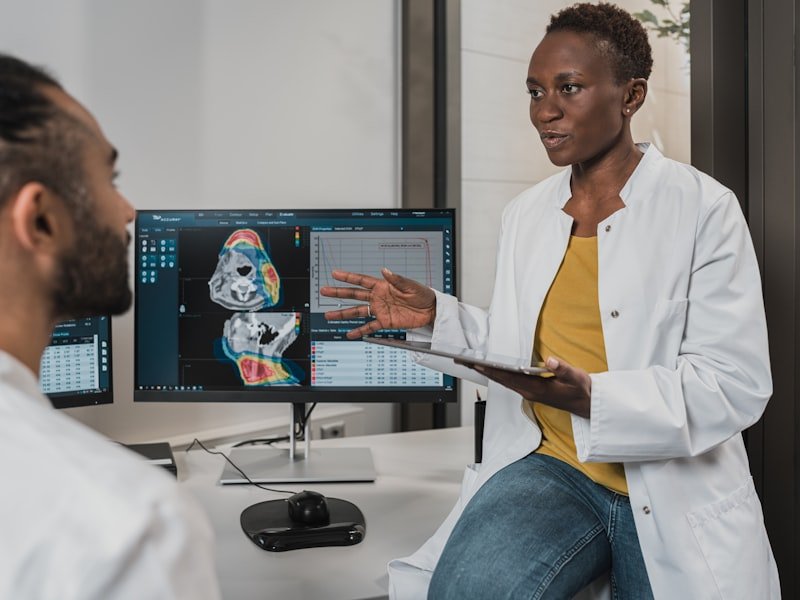 Doctor reviewing medical imaging with a patient — spinal cord and catastrophic impairment